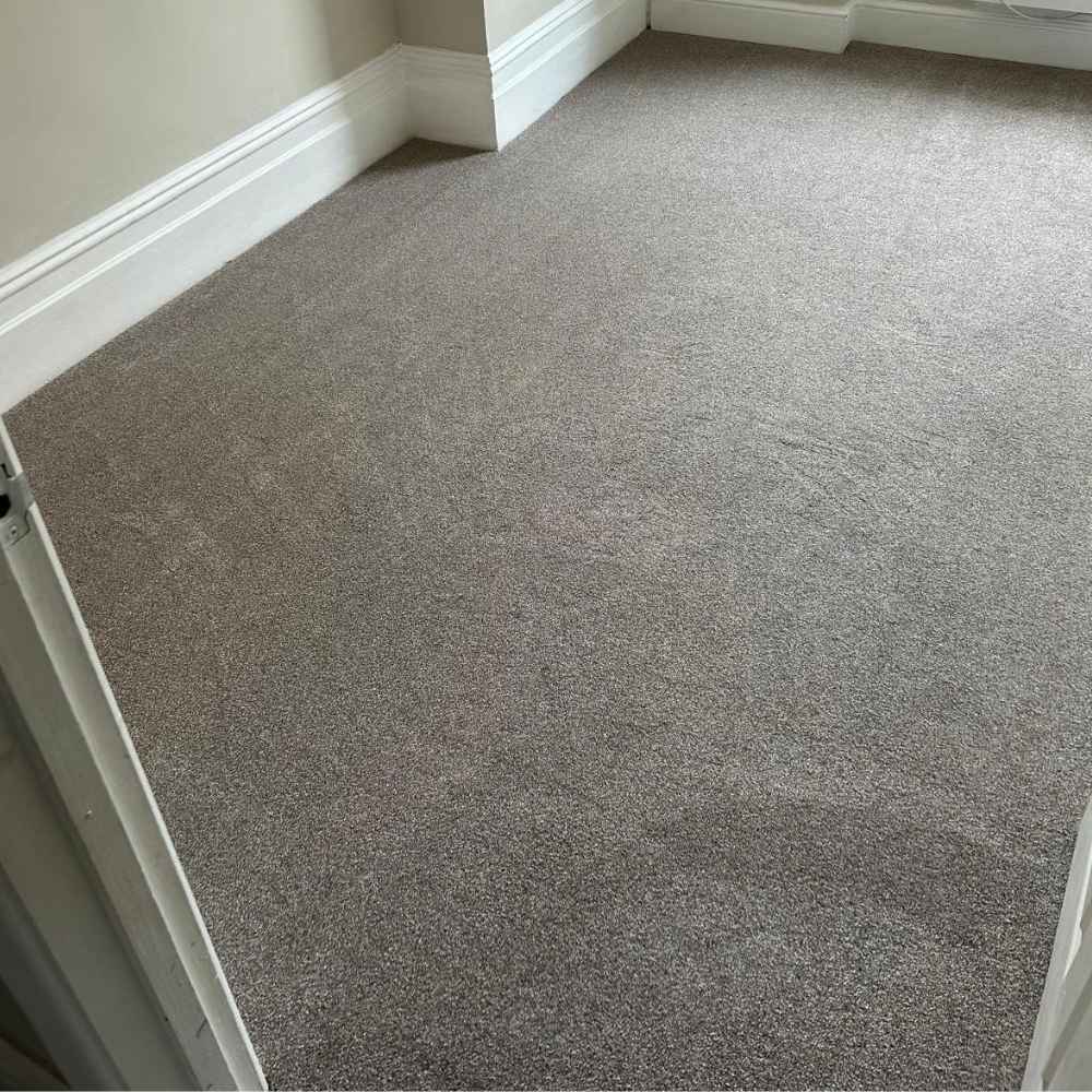 A bedroom fitted with Harmony Twist Carpet in Bournemouth by Carpetly